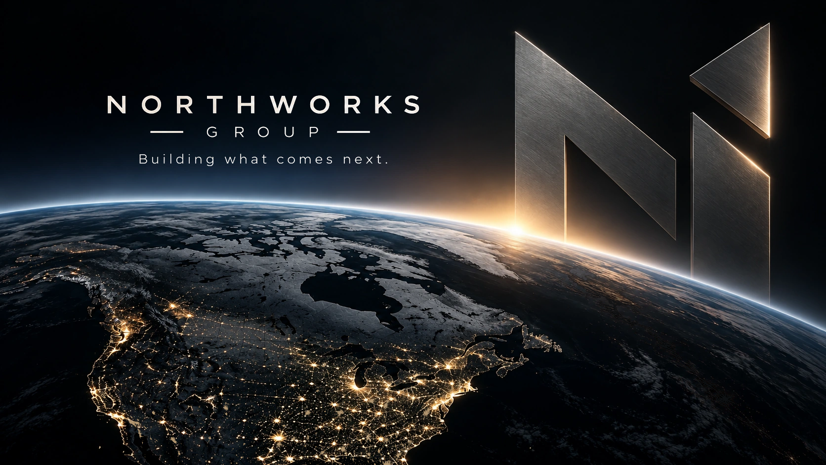 A monumental titanium N catches the sunrise above Canada and North America at night.